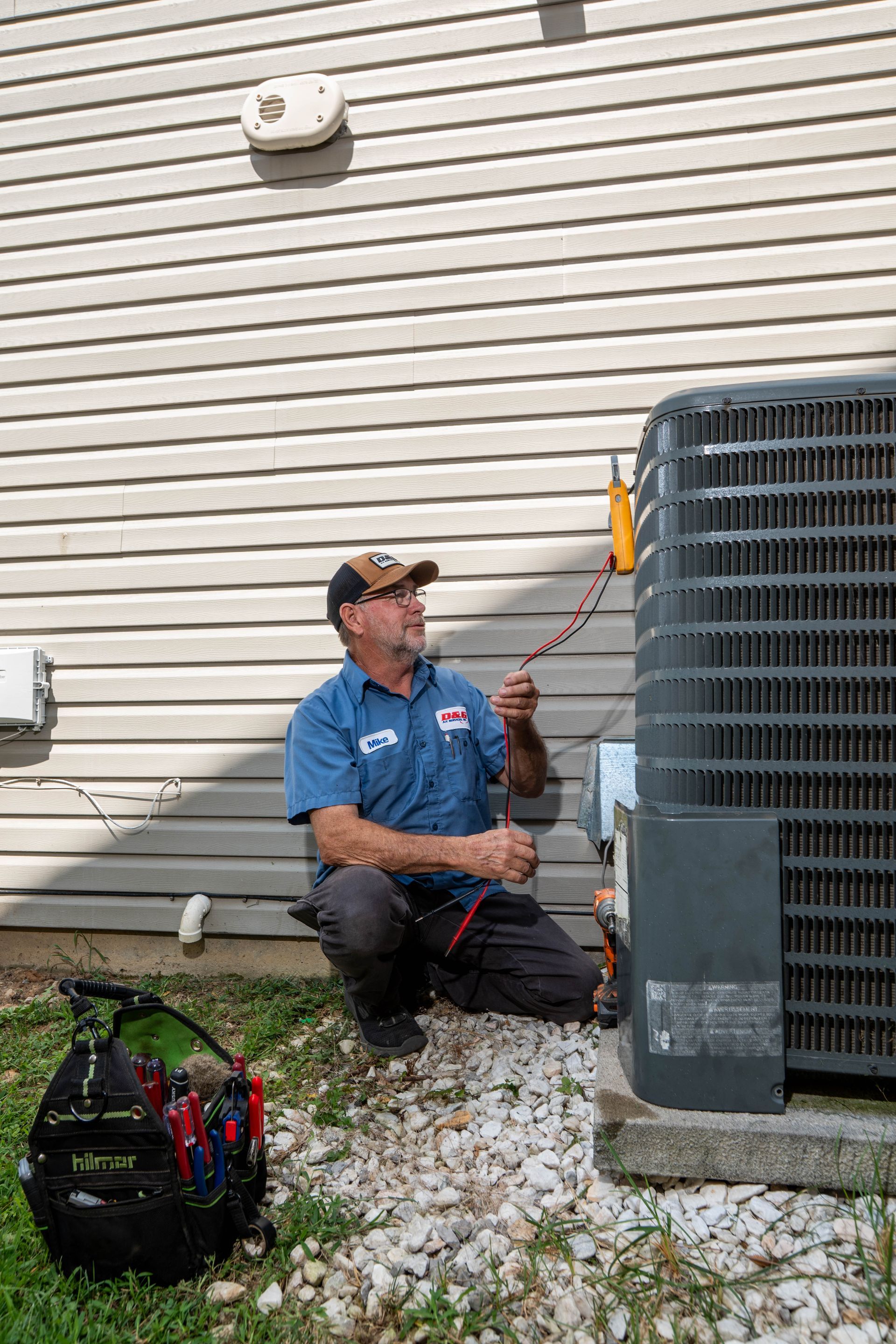 D&G technician checking an outdoor HVAC system