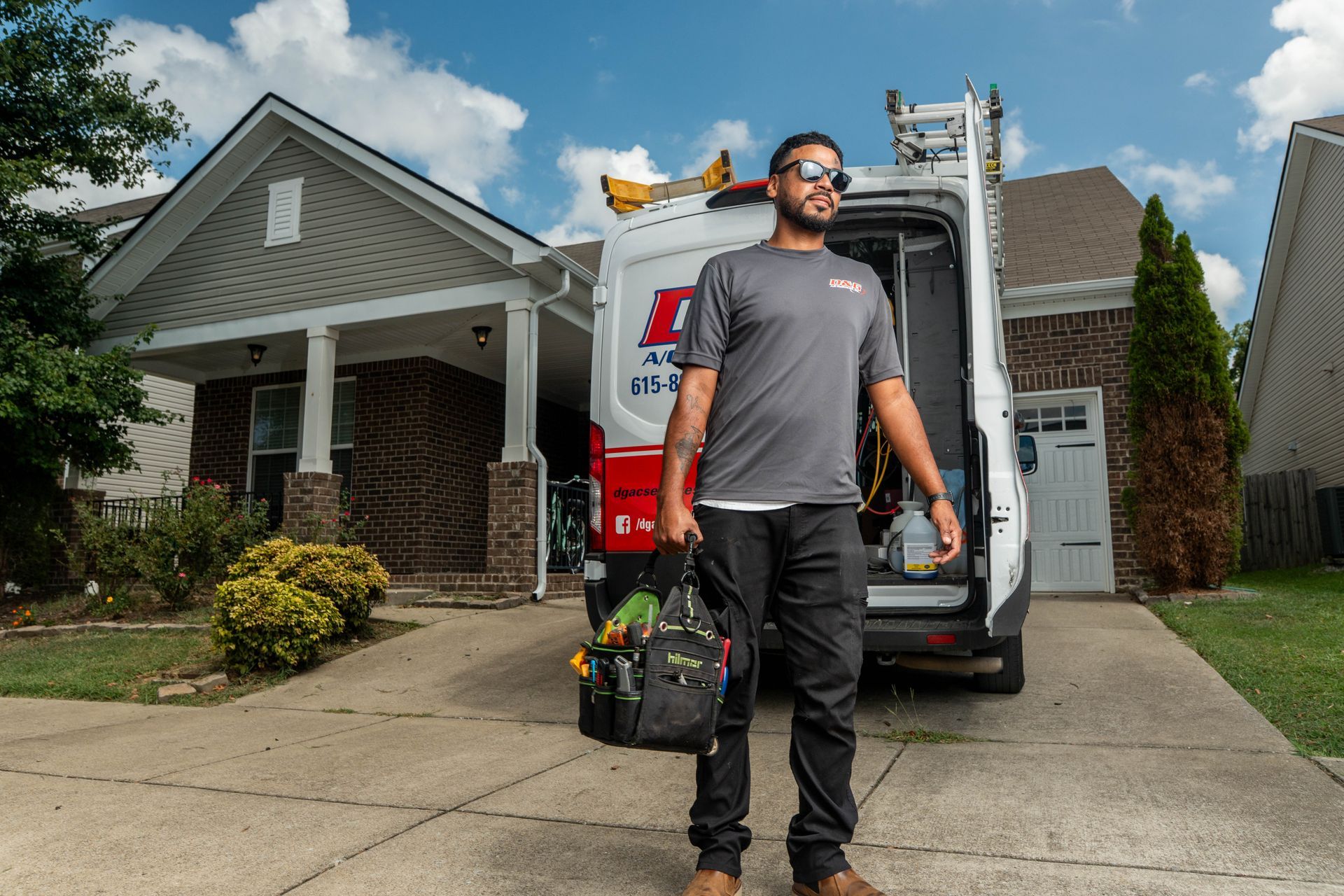 D&G A/C Services technician arriving at a Nashville home with a service van